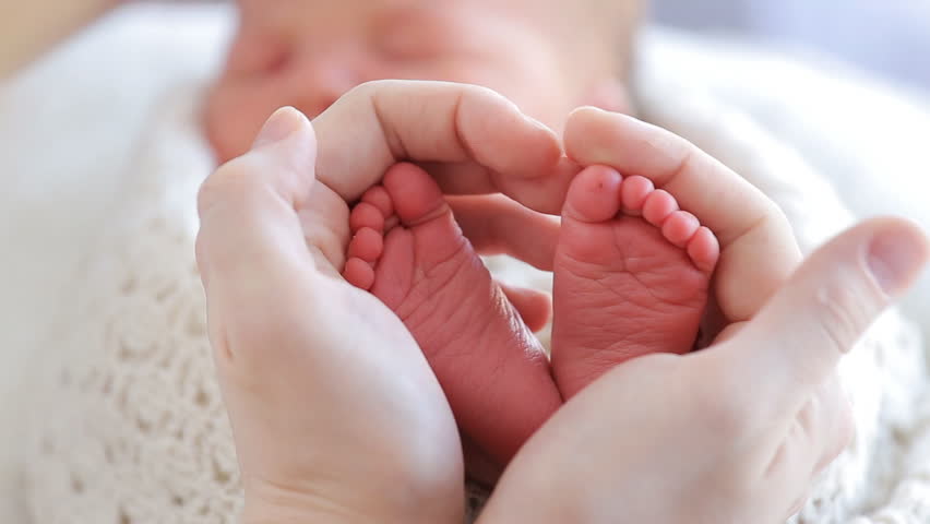 Mother's Hands in a Heart around Baby's Feet.jpg